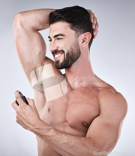 Image of Cosmetics, deodorant and man with smile, product and wellness on grey studio background. Perfume for arm pit, confident male and gentleman with happiness, fragrance and morning routine for grooming