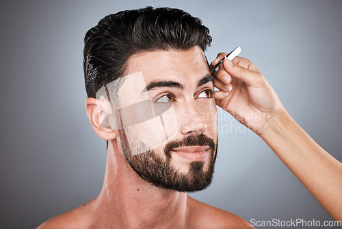 Image of Face, barber and man with tweezers in studio isolated on a gray background for wellness. Thinking, hair removal and male model with facial product to pluck eyebrows for grooming and beauty at salon.