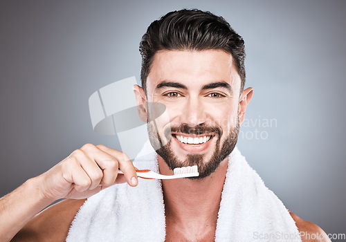 Image of Man, toothbrush and portrait smile for dental care, hygiene or skincare against a gray studio background. Happy male face smiling for clean teeth, oral or brushing mouth for morning grooming routine