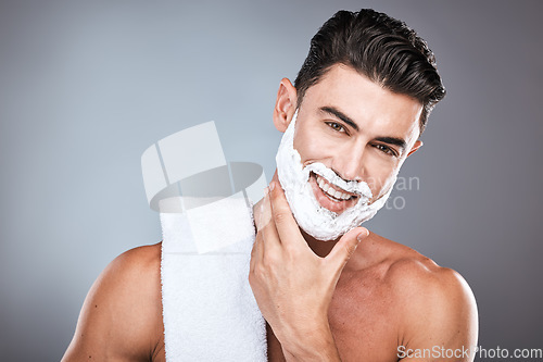 Image of Portrait, shaving cream and grooming with a man model in studio on a gray background for hair removal. Face, hand and skincare with a handsome young male in the bathroom for a shave in the morning