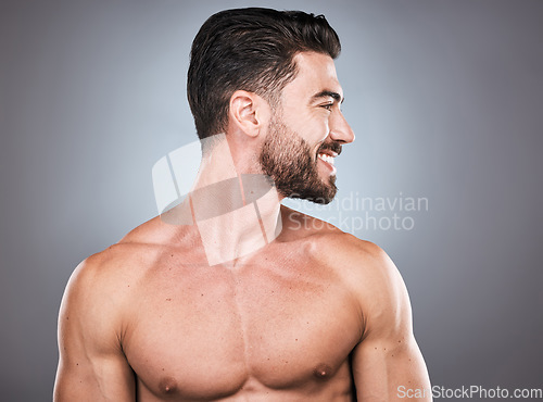 Image of Face, beard and skincare with a man model topless in studio on a gray background for hygiene or grooming. Health, wellness and aesthetic with a muscular or handsome male posing shirtless indoor