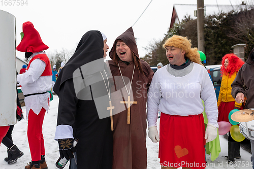 Image of Peoples in mask attend Masopust or the Mardi Gras carnival, traditional ceremonial door-to-door procession. 