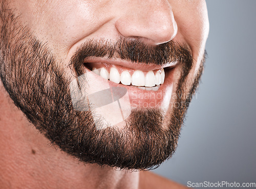 Image of Smile, dental health and mouth of a man with teeth isolated on grey studio background. Happy, showing and beard of a model with results from tooth whitening, dentist cleaning and hygiene on backdrop