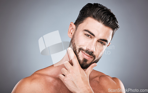 Image of Skincare, face and confidence, portrait of man with smile, hands on facial hair or beard maintenance. Fitness, health and spa facial care, male model with muscle in studio isolated on grey background
