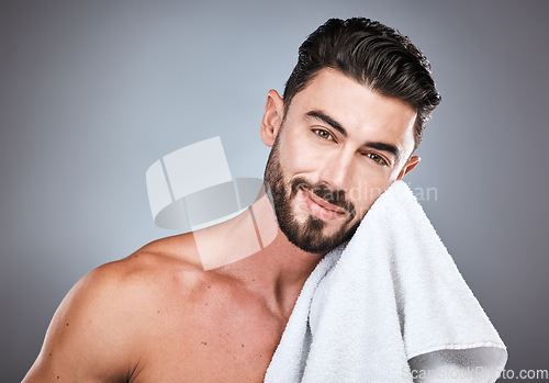 Image of Skincare, health and portrait of a man in a studio with a cosmetic, natural and face routine. Wellness, healthy and handsome male model with a facial towel for treatment isolated by a gray background