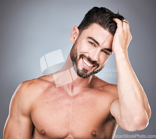 Image of Skincare, smile and portrait of man with hand in hair, sexy beard maintenance and healthy beauty. Fitness, health and spa facial care, male model with muscle in studio isolated on grey background.