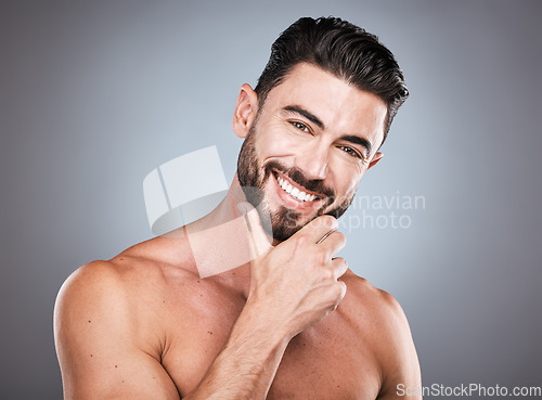 Image of Skincare, beauty and smile, portrait of man with hand on face and hair or beard maintenance. Fitness, health and spa facial care, happy male model with muscle in studio isolated on grey background.