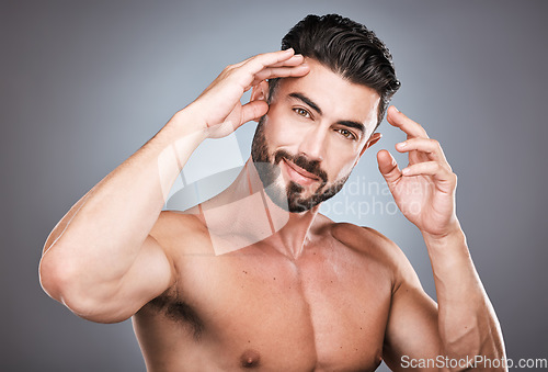 Image of Skincare, beauty and health, portrait of man with smile, hands on head and hair or beard maintenance. Fitness, health and spa facial care, male model with muscle in studio isolated on grey background