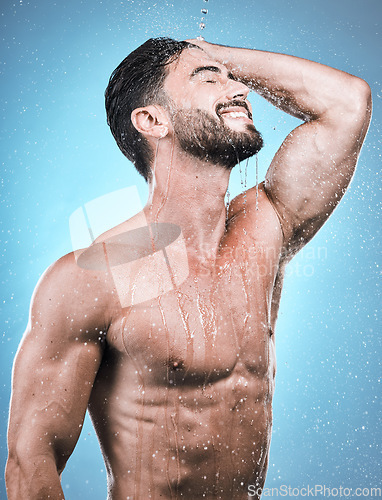 Image of Body, man and water for cleaning, morning routine and grooming against a blue studio background. Skincare, male and gentleman with cosmetics, wet and drops for hygiene, beauty or wellness on backdrop