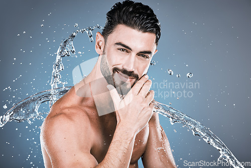 Image of Water splash, beauty and shower with man in portrait for hygiene and skincare isolated on studio background. Hand, face and cleaning body with muscle, sustainable dermatology with natural cosmetics