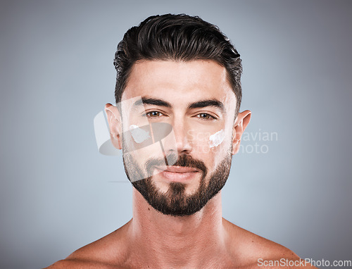 Image of Skincare, cream and face portrait of man in studio isolated on a gray background for wellness. Cosmetics, dermatology and young male model with lotion, creme or moisturizer product for facial health.
