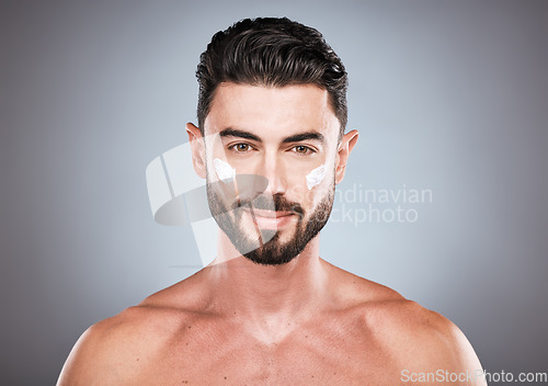 Image of Face portrait, skincare cream and man in studio isolated on a gray background for wellness. Cosmetics, dermatology and young male model with lotion, creme or moisturizer product for facial health.