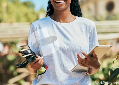 Image of Woman, hands or gardening equipment with tablet for plant growth management, agriculture or sustainability work. Smile, happy or farmer and technology, tools or environment rake for field development