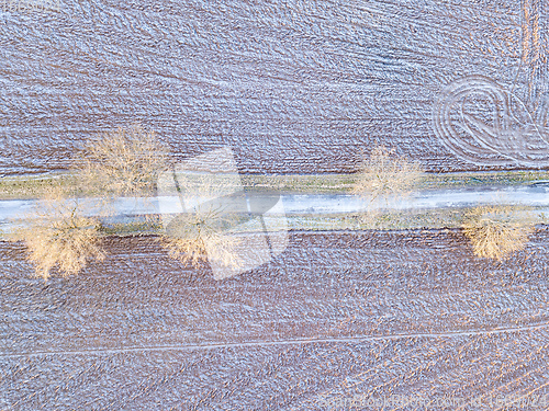 Image of winter road with frost covered fields