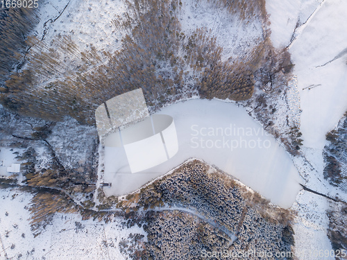 Image of Aerial top down view of beautiful winter forest treetops.