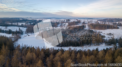 Image of Aerial top down view of beautiful winter forest treetops.