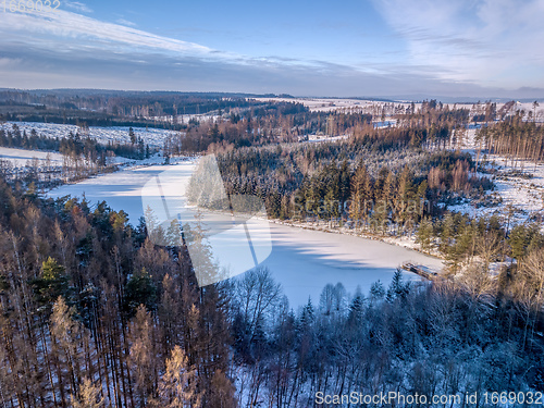 Image of Aerial top down view of beautiful winter forest treetops.