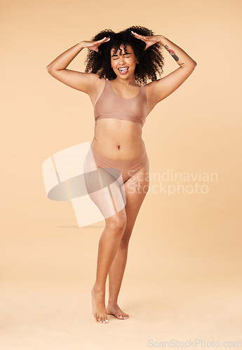 Image of Hair care, tongue out and beauty of black woman in lingerie in studio isolated on a brown background. Underwear, skincare and cosmetics of happy young model with spa treatment for growth and texture.