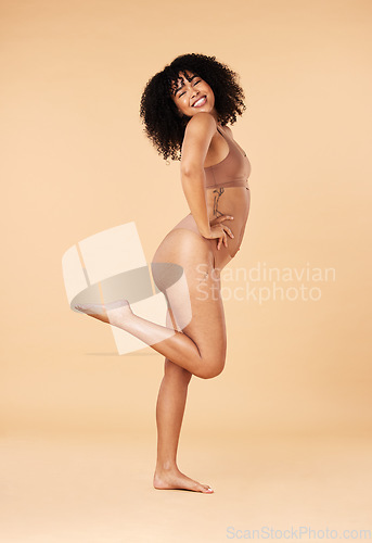 Image of Body positivity, confident and portrait of a woman in underwear isolated on a beige studio background. Cheerful, smile and lingerie model with freedom, happiness and attractive in bikini fashion