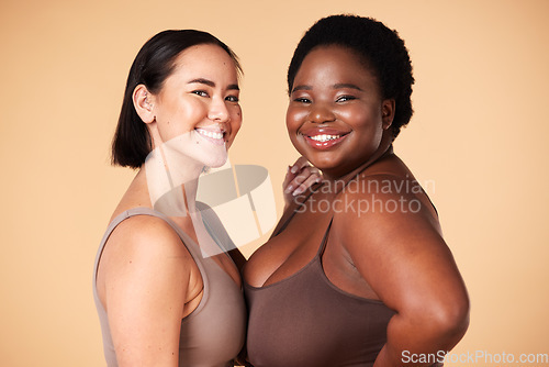 Image of Friends, diversity and beauty of plus size women in studio isolated on a brown background. Empowerment portrait, underwear and body positive happy girls with makeup, cosmetics and healthy skincare.