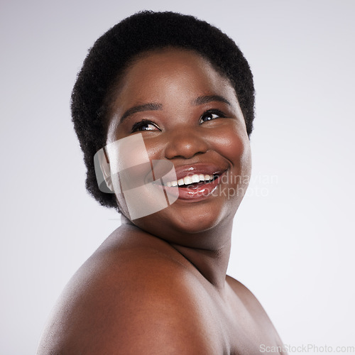 Image of Face, thinking and beauty with a model black woman in studio on a gray background for skincare. Idea, skin and happy with a plus size young female posing indoor for natural care or body positivity