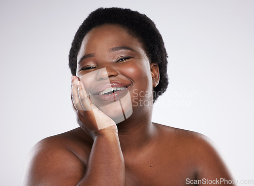 Image of Black woman, hand and smile for skincare beauty, cosmetics or makeup against gray studio background. Portrait of happy natural plus size African American female smiling for self love, care or facial
