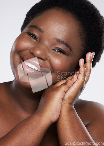 Image of Black woman, hands and smile for gentle skincare beauty, cosmetics or makeup against a gray studio background. Portrait of happy African American female touching face for natural self love or care