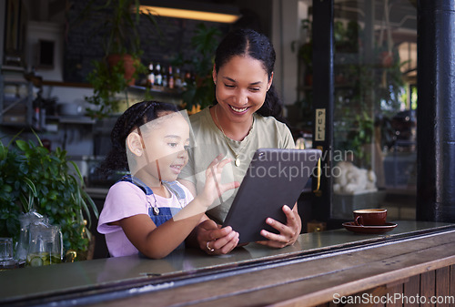 Image of Digital tablet, cafe and mother with her child reading the online menu before ordering. Technology, internet and mom on a date with her girl kid with a touchscreen mobile device in a coffee shop.