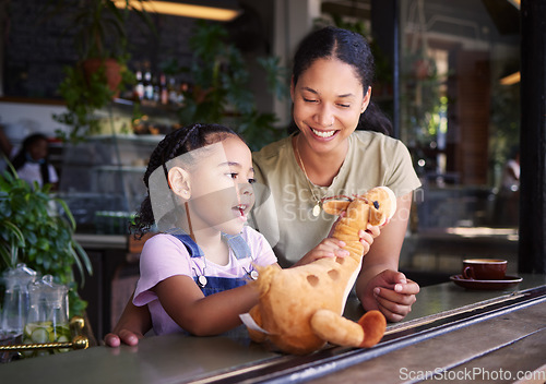 Image of Black family, coffee shop or stuffed animal with a mother and daughter sitting in the window of a restaurant together. Kids, love or toys with a woman and female child bonding in a cafe on a weekend