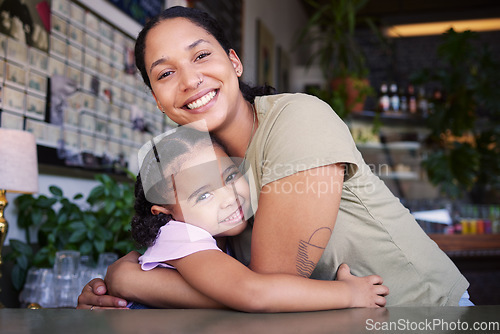 Image of Cafe, portrait and mother hug kid in coffee shop for love, care or quality time together. Happy parent hugging girl child in restaurant at table of happiness, smile and embrace for bond, relax or fun