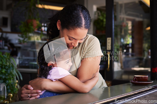 Image of Cafe, mom and child hug in restaurant for love, care and quality time together. Happy mother hugging girl kids in coffee shop at table for happiness, smile and embrace for bonding, relaxing and fun
