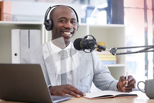 Image of Portrait, laptop and radio with a black man presenter writing in a notebook during a live broadcast. Computer, podcast and microphone with a male journalist working in media for a talk show or press