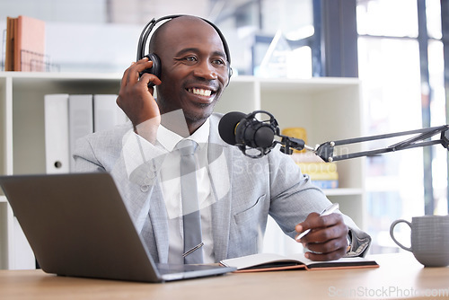 Image of News, laptop and radio with a black man presenter writing in a notebook during a live broadcast. Computer, podcast and microphone with a male journalist working in media for a talk show or press