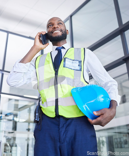 Image of Black man, construction or phone call in building planning, networking or industrial property renovations in low angle. Smile, happy or building worker with mobile technology, helmet or vision ideas