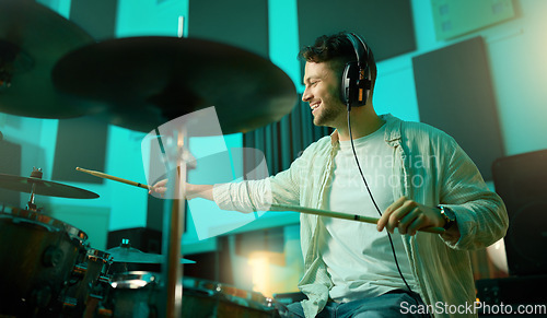 Image of Music, drums and band with a man musician in a studio for a recording, performance or practice. Art, instrument and sound with a young male drummer expressing musical or artistic talent in a studio