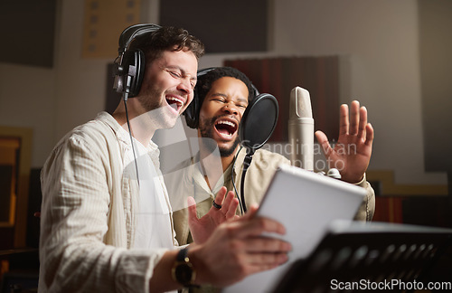 Image of Music, singing and men recording in studio tablet, streaming with microphone, headphones and talent. Technology, art and creative influencer band and musician with live stream song for record label.