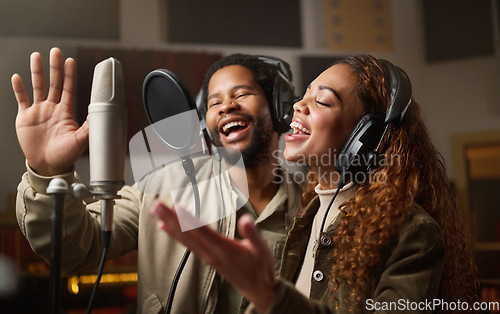 Image of Music, streaming and black couple recording in studio, singing into microphone with headphones and radio. Technology, art and creative influencer band, man and woman live stream song for record label