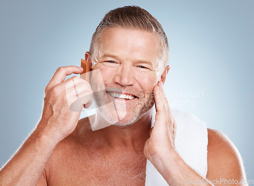 Image of Skincare, grooming beard and portrait of man with comb for wellness, cleaning and hygiene on blue background. Salon aesthetic, beauty and face of male with barber tools for facial, hair care and skin