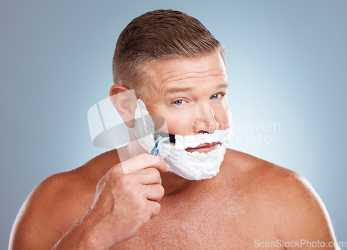 Image of Shaving cream, face and man with razor in studio isolated on a gray background for hair removal. Portrait, skincare and mature male model with facial foam to shave for aesthetics, health or wellness