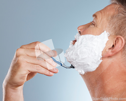 Image of Razor, face and man with shaving cream in studio isolated on a gray background for hair removal. Profile, skincare and senior male model with facial foam to shave for aesthetics, health or wellness.