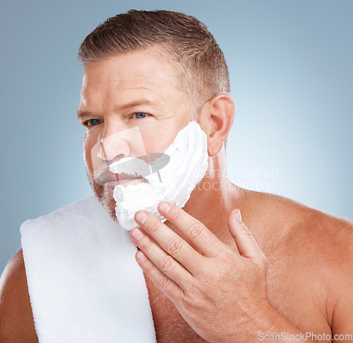 Image of Shaving cream, product and old man in studio for skincare, grooming and beauty on grey background. Face, foam and hair removal for mature model relax with luxury, beard and treatment while isolated