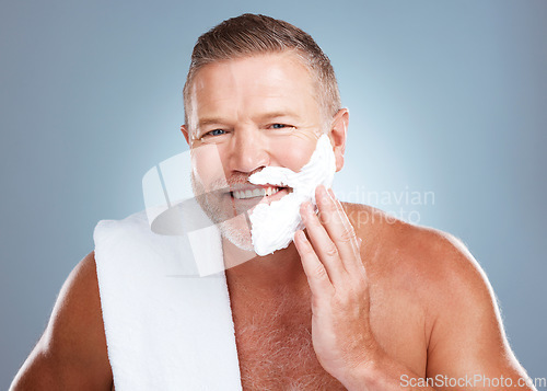 Image of Shaving beard, smile and man portrait with cream and razor for face cleaning, wellness and skincare. Morning grooming, foam and model with facial care and skin treatment to shave hair in a studio