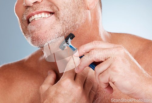 Image of Epilation, razor and man shaving his face in a studio for a facial, skincare and hygiene routine. Health, wellness and mature male doing face hair removal treatment with a shaver by gray background.