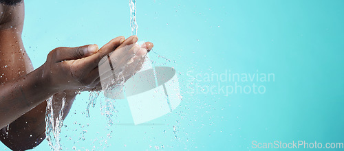 Image of Water, black man and cleaning hands with mockup space, wash face and skincare isolated on blue background. Healthy skin, clean cosmetics and grooming, hygiene and beauty sustainability in studio