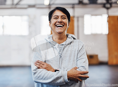 Image of Arms crossed, laughing and portrait of a woman in the gym for fitness, training and exercise. Motivation, happy and funny mature athlete with cardio vision, workout smile and confidence in sports