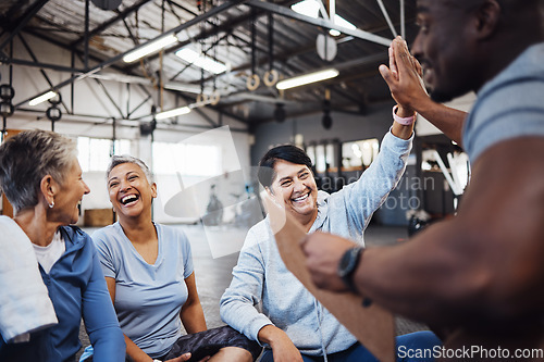 Image of High five, group or team of fitness senior women at the gym after exercise, workout or training with personal trainer. Elderly, old and people happy, smile and excited for teamwork and motivation