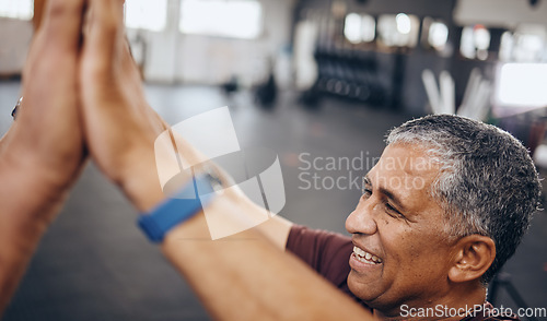 Image of Senior man, high five and exercise in gym, smile and achievement for workout goal and target. Mature male, athlete and gesture for celebration, winning and fitness with support, happiness or wellness
