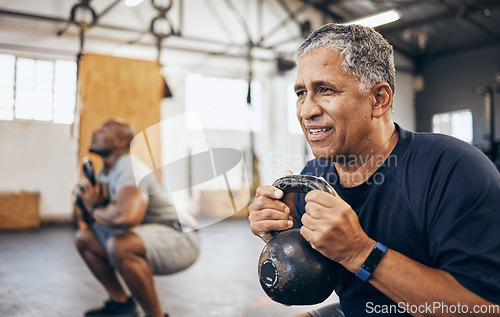 Image of Training, senior and man exercise with personal trainer at the gym squat with kettlebell equipment for strength. Elderly, old and fitness people workout in a health club for wellness and motivation