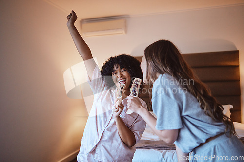 Image of Women, karaoke and singing in bedroom with brush and pjs, friends get ready for crazy girls night out, music concert and happiness. Girl, friend and happy smile, girlfriends at sleepover in pajamas.