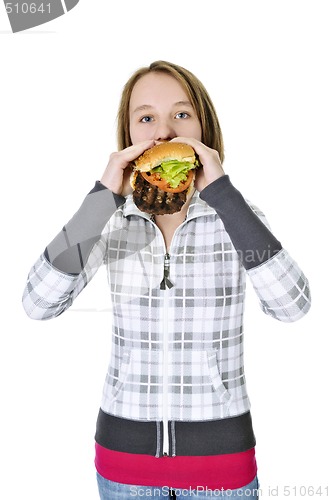 Image of Teenage girl eating big hamburger